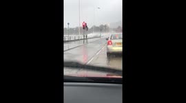 Storm Brendan: Waves crash over cars in Whiteabbey, County Antrim
