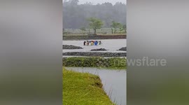 Kindhearted neighbours carry sick man on stretcher across river to Philippines hospital