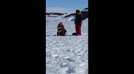 Granddaughter ice jigging well grandma watches