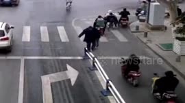 Chinese man walks along guardrails on busy road to check his blood pressure