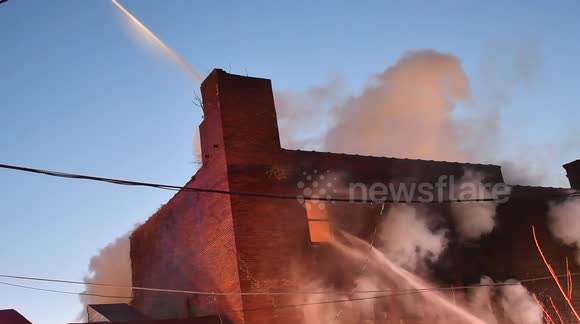 Pennsylvania firefighters attack burning factory in frigid conditions
