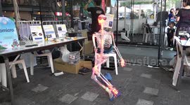 Flashing LED skeleton takes a break at inventor exhibition in Bangkok