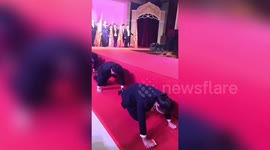 Chinese workers crawl on their hands and knees after missing targets