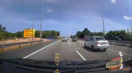 Reckless driver undertakes across four lanes before knocking over motorcycle rider in Malaysia