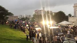 Protestors against the government of Puerto Rico are gathered under the heavy rain