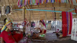 Mother from Long Neck tribe hand weaving a silk scarf