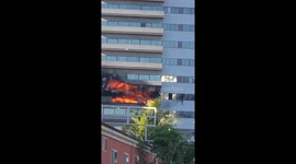 Firemen saving man from burning building on Wilshire Blvd. Los Angeles
