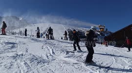 Front facing camera chase of a silhouetted speeding Skier while skiing backwards and avoiding traffic in Bunsko, Bulgaria