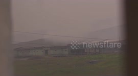 A woman plays with the dog in russian Arctic