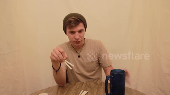 US man struggles to eat entire pack of cigarettes in reckless viral challenge