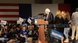 Iowa Caucus Night: Sanders speaks on stage (side shot showing whole crowd)