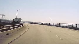 California driver captures moment truck overturns on windy day