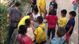 Cheeky youngsters take turns secretly swigging from bottle of sparkling wine