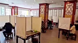 Dining tables in Chinese noodle bar surrounded by curtains to avoid spread of coronavirus