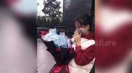 Chinese girl receives bunch of flowers packed with masks and ethyl on Valentine's Day during coronavirus outbreak