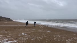 Thrill-seekers risk lives to dodge huge waves from Storm Dennis on UK beach