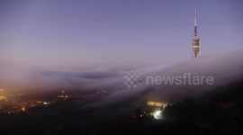 Stunning timelapse shows clouds flowing down hillside in Barcelona