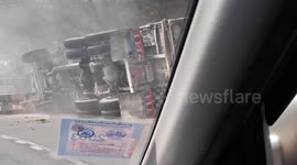 Truck trying to escape the police topples over on sharp bend in Thailand