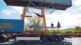 Slovenian acrobats perform daring stunts on trampoline attached to moving truck and shipping container