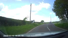 Dirt biker tries to wheel spin mud and stones onto passing vehicle