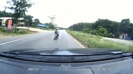 Car narrowly misses motorcycle suddenly changing its lane on Thai highway