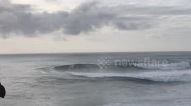 Surfer narrowly makes it out of path of oncoming monster wave during World Surf League Tow Surf Challenge at Nazaré, Portugal