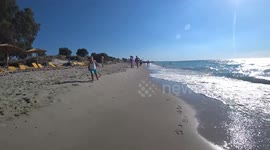 son with dad chasing on the beach