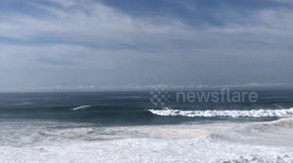 Surfers making the most of the Big Wave Season at Nazaré, Portugal