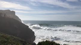 Huge waves at Nazaré, Portugal create thunderous sound as they crash along the shoreline