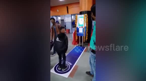 Commuters perform squats to be eligible for free tickets at a railway terminal in the Indian capital Delhi