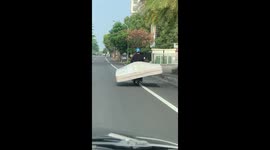 Motorcyclist carries double matters on his bike