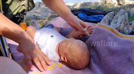 Putting sun cream on infant baby