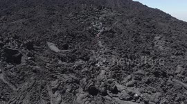 Tourists walk on lava to grill marshmallow on Pacaya volcano in Guatemala