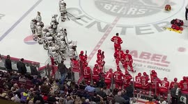 Hershey Bears and Charlotte Checkers watch as medical personnel attend to Hershey forward Kale Kessy who was motionless on the ice following a hockey fight