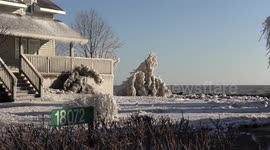 Epic houses encased in ice from freezing spray that rain down from Lake Erie in Canada during high wind and severe weather event