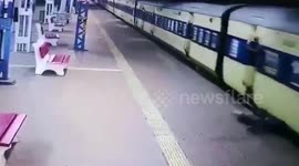 Frightening moment a man gets dragged along by a moving train