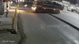 Pedestrian barely dodges collision between two lorries on south Indian road