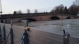 River Severn high level up against metal flood barriers in Bewdley
