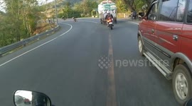 Hair-raising moment motorcyclist narrowly misses oncoming cars in the Philippines