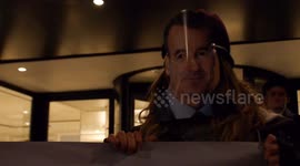 Climate protesters wear masks of BP's CEO outside oil industry dinner