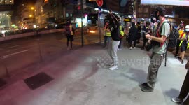 Hong Kong protesters show defiance to riot police as tear gas is fired