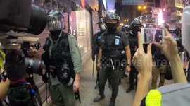 Riot police confront journalists on Hong Kong's Nathan Road