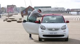 Tall order! Real-life BFG who is over 7ft drives around in TINY smart car