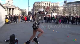 Roller skater demonstrates a funny trick in Trafalgar Square - London