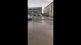 Lonely man with heart ballon in rain and wind