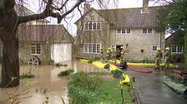 Firefighters pump out water from flooded home in Weymouth, UK