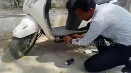 Smuggler caught hiding 250 cartons of liquor inside scooter in Gujarat, western India