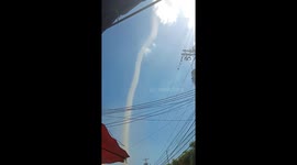 Dust devil rips through street in the Philippines knocking over a taxi