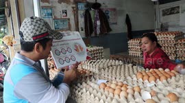 Health volunteers provide advice on how to slow spread of Coronavirus at market in Indonesia