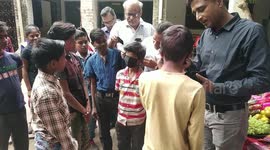 Social workers give masks to orphan children for Indian festival gifts